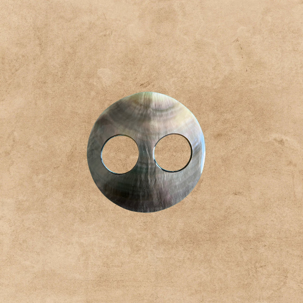 Handmade sea shell sarong buckle on a sandy background