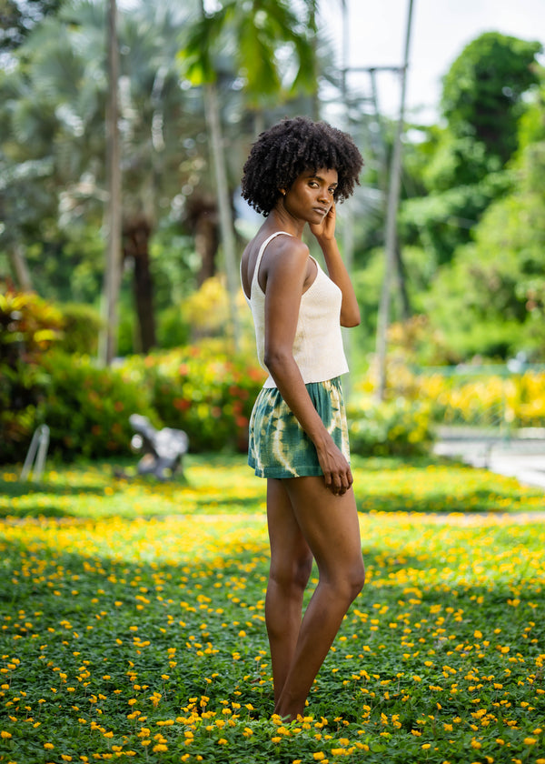 Rear three-quarter view of BLISS green and yellow tie-dye shorts