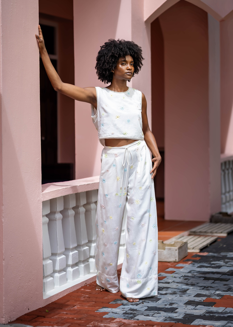Kendra wearing the cream Marguerites set against pink arches during the Botanica campaign