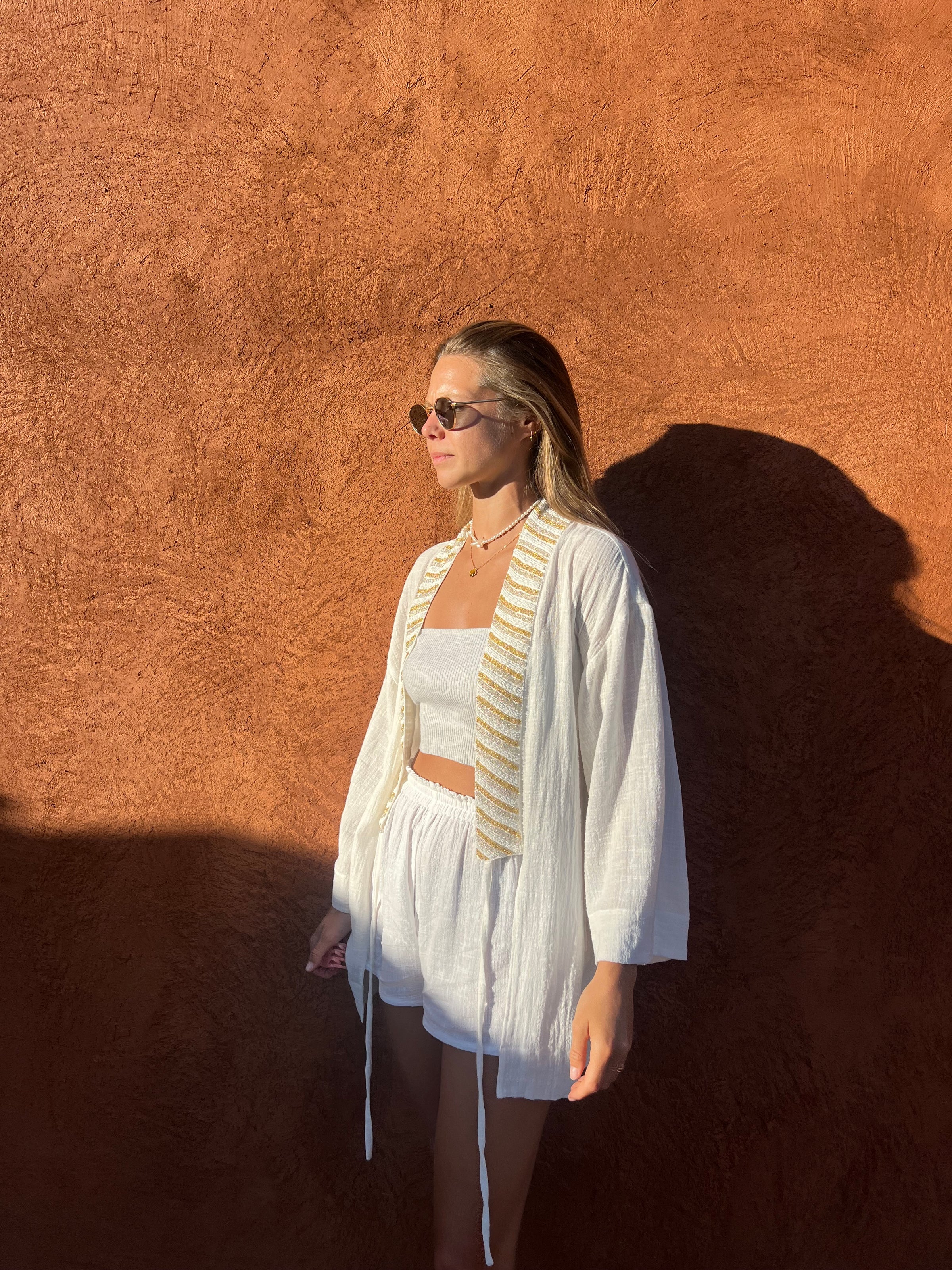 Model wearing SUKI white kimono with BLISS white shorts