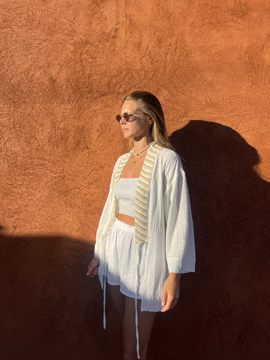 Model wearing SUKI white kimono with BLISS white shorts