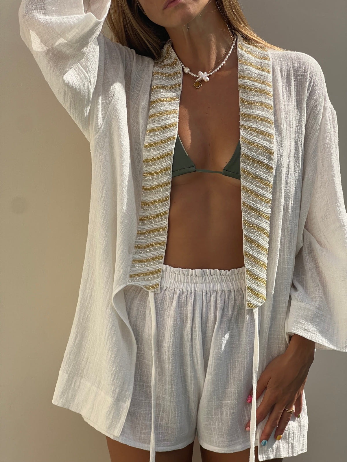 Close-up of BLISS white shorts showing loose fit and texture