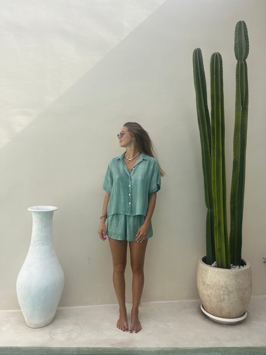 AURA green tie-dye shirt worn open over a bikini