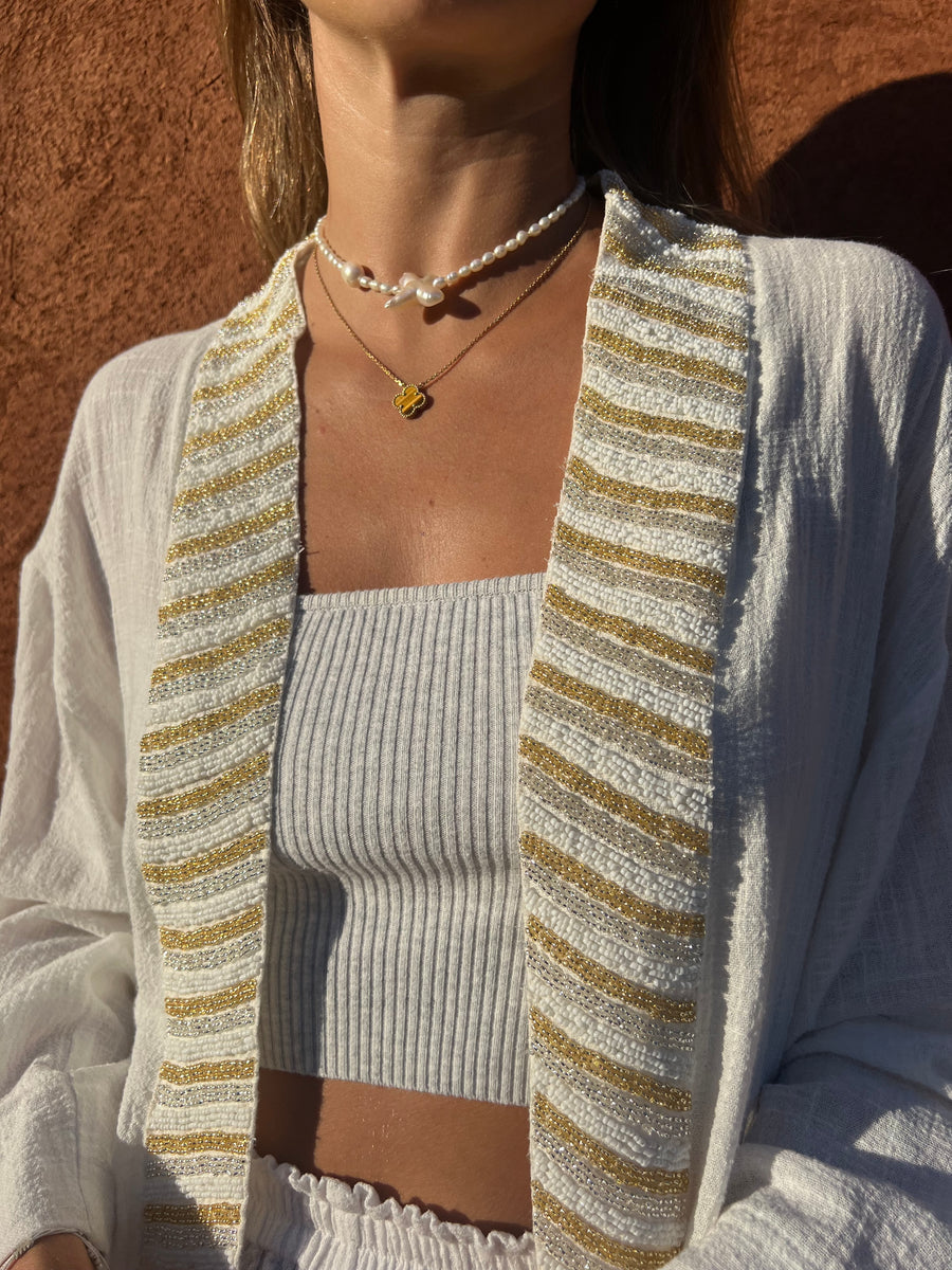 Close-up of SUKI white kimono trim with BLISS white shorts