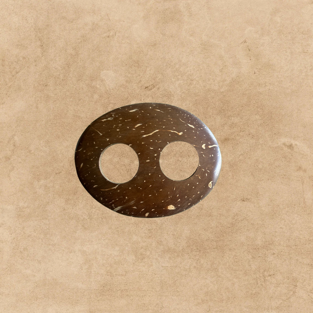 Handmade coconut shell sarong buckle on a sandy background