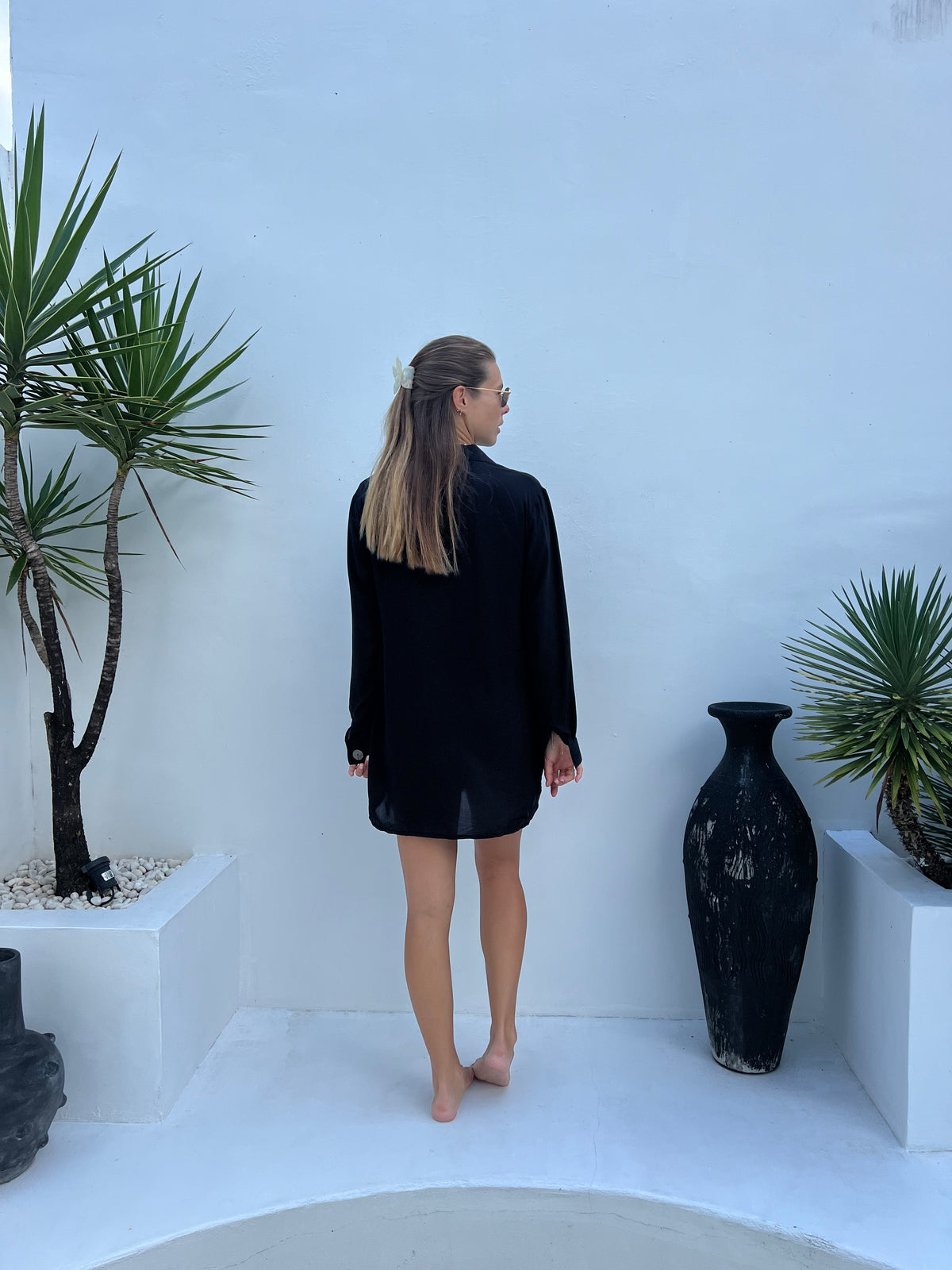 Model in MILA black shirt dress styled as a mini dress