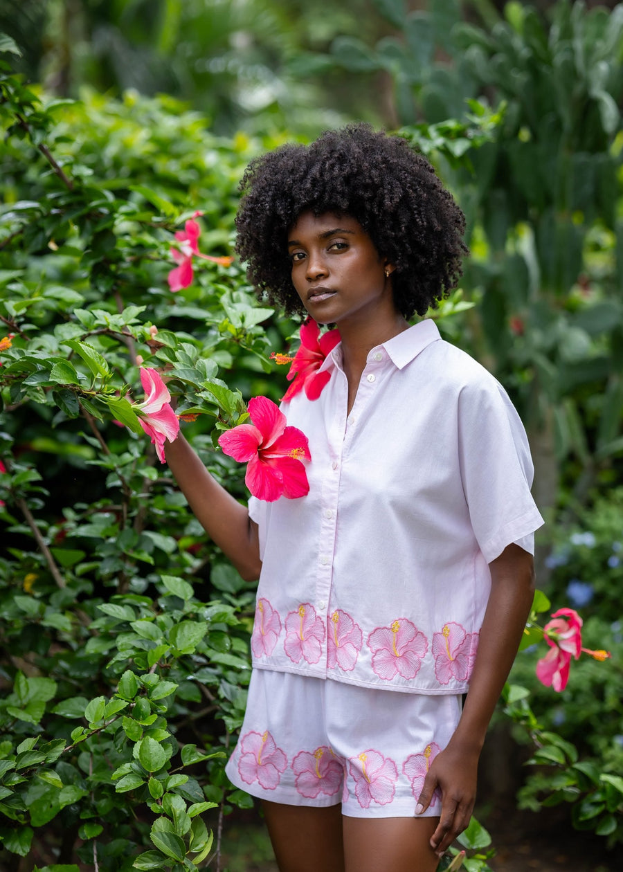 Three-quarter view of the matching AURA Shirt and BLISS Short HIBISCUS set in pink