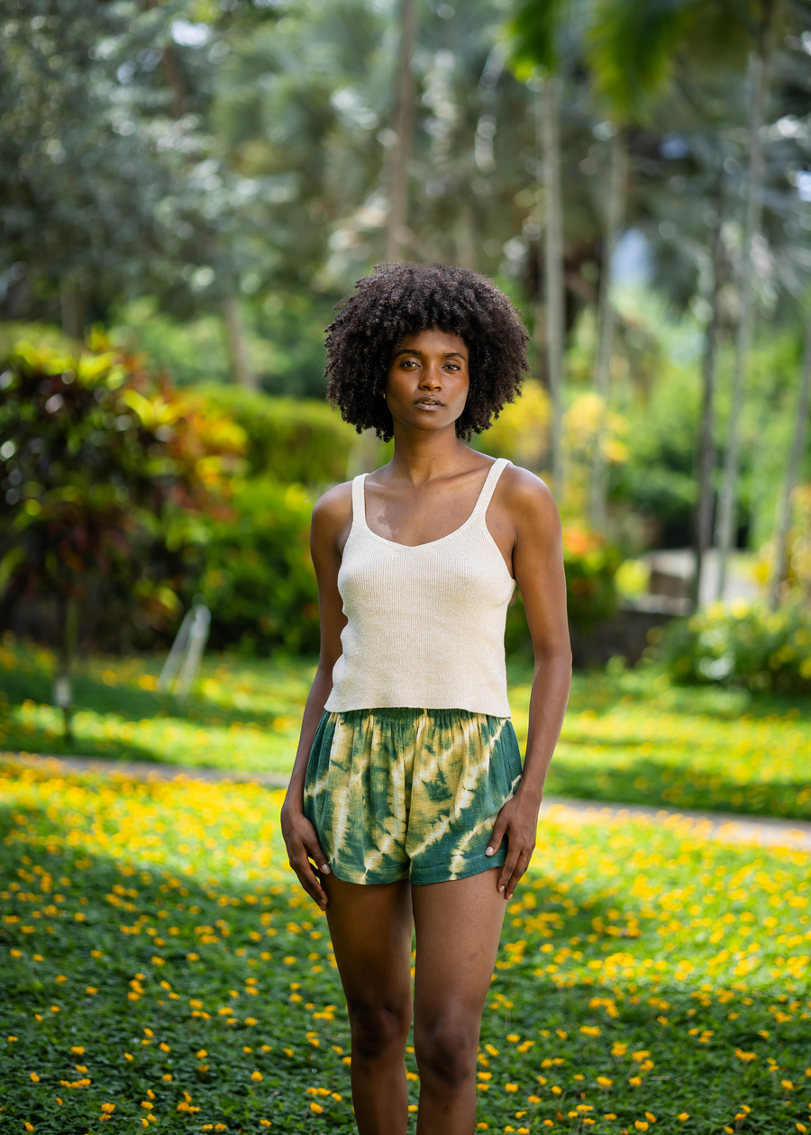 Straight-on full-length view of BLISS green and yellow tie-dye shorts
