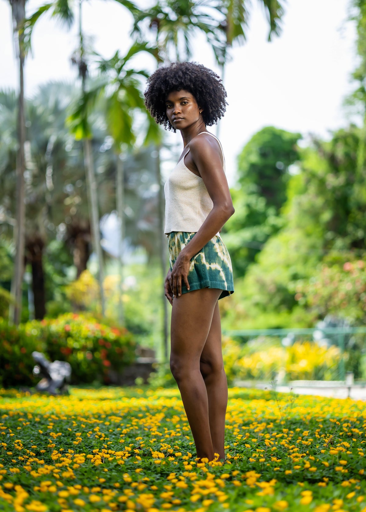 Side view of BLISS green and yellow tie-dye shorts