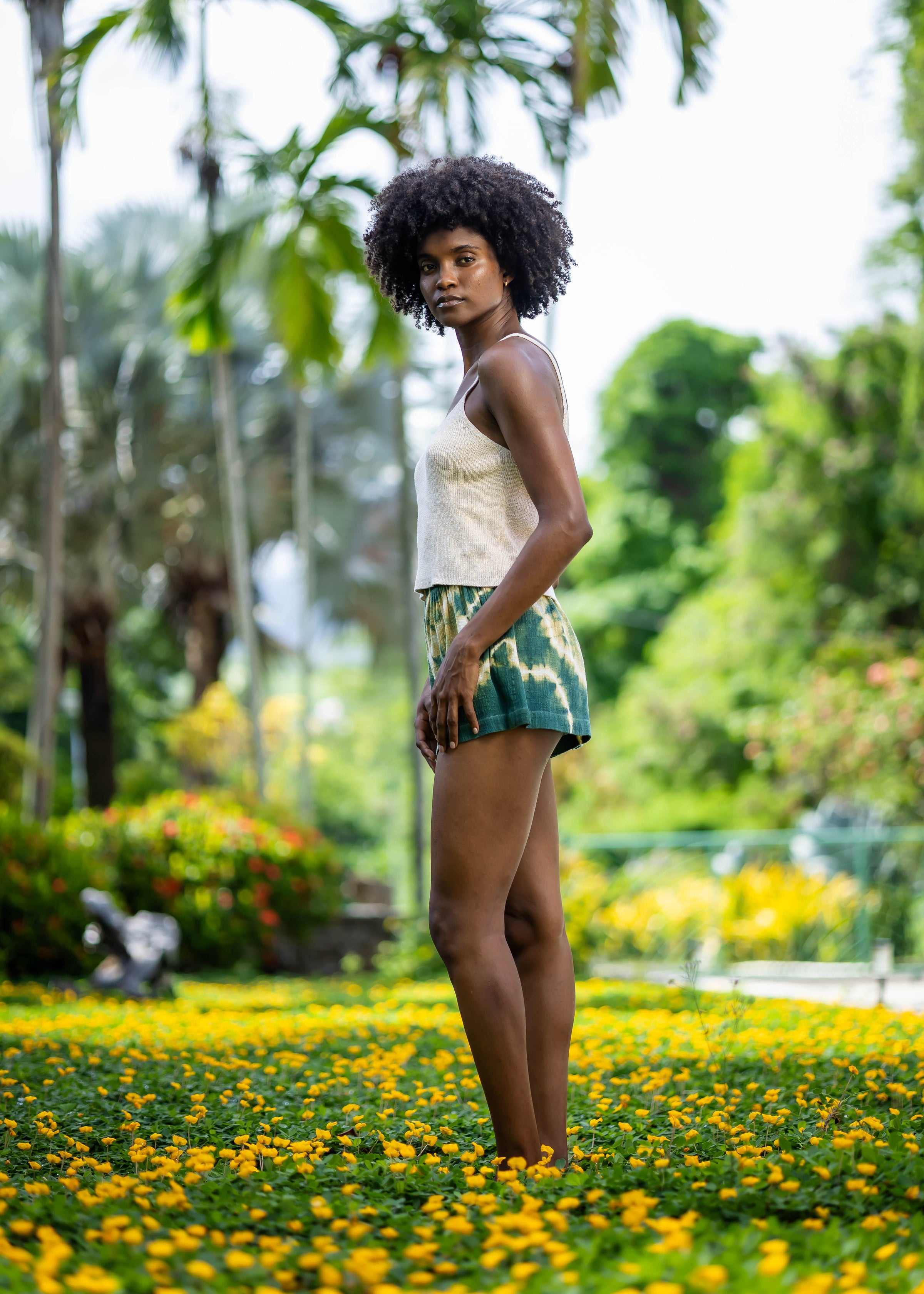 Side view of BLISS green and yellow tie-dye shorts