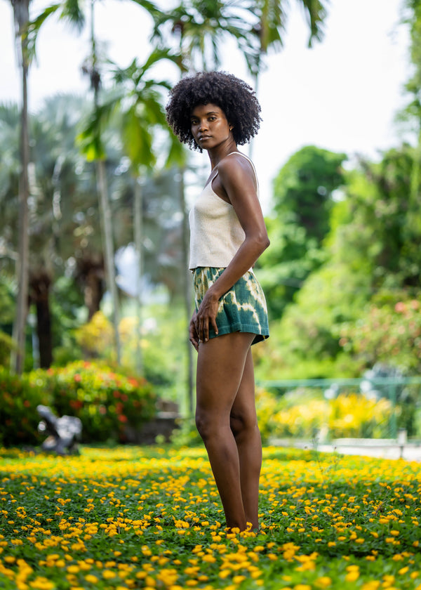 Side view of BLISS green and yellow tie-dye shorts