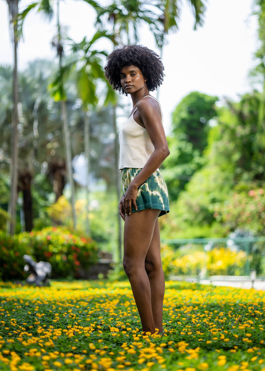 Side view of BLISS green and yellow tie-dye shorts