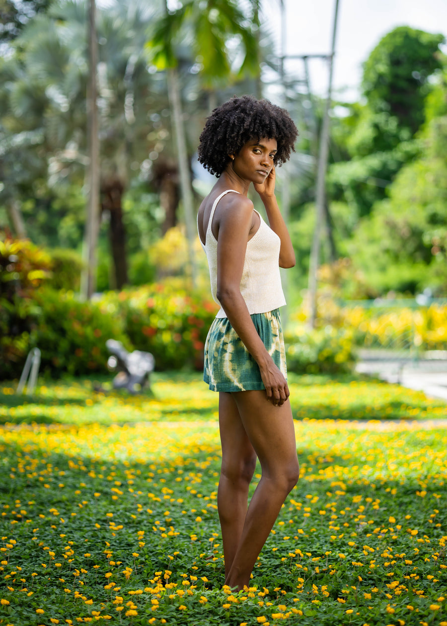 Rear three-quarter view of BLISS green and yellow tie-dye shorts